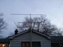 Notice my son on the roof of the house, and take a look at the workmanship in the design and construction of the tower and 6 and 2 meter yagis.

18 elements 70cm
8 elements 2 meters
3 elements 6 meters